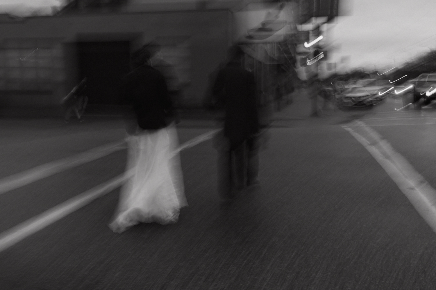 couple crossing a Vancouver street in black and white